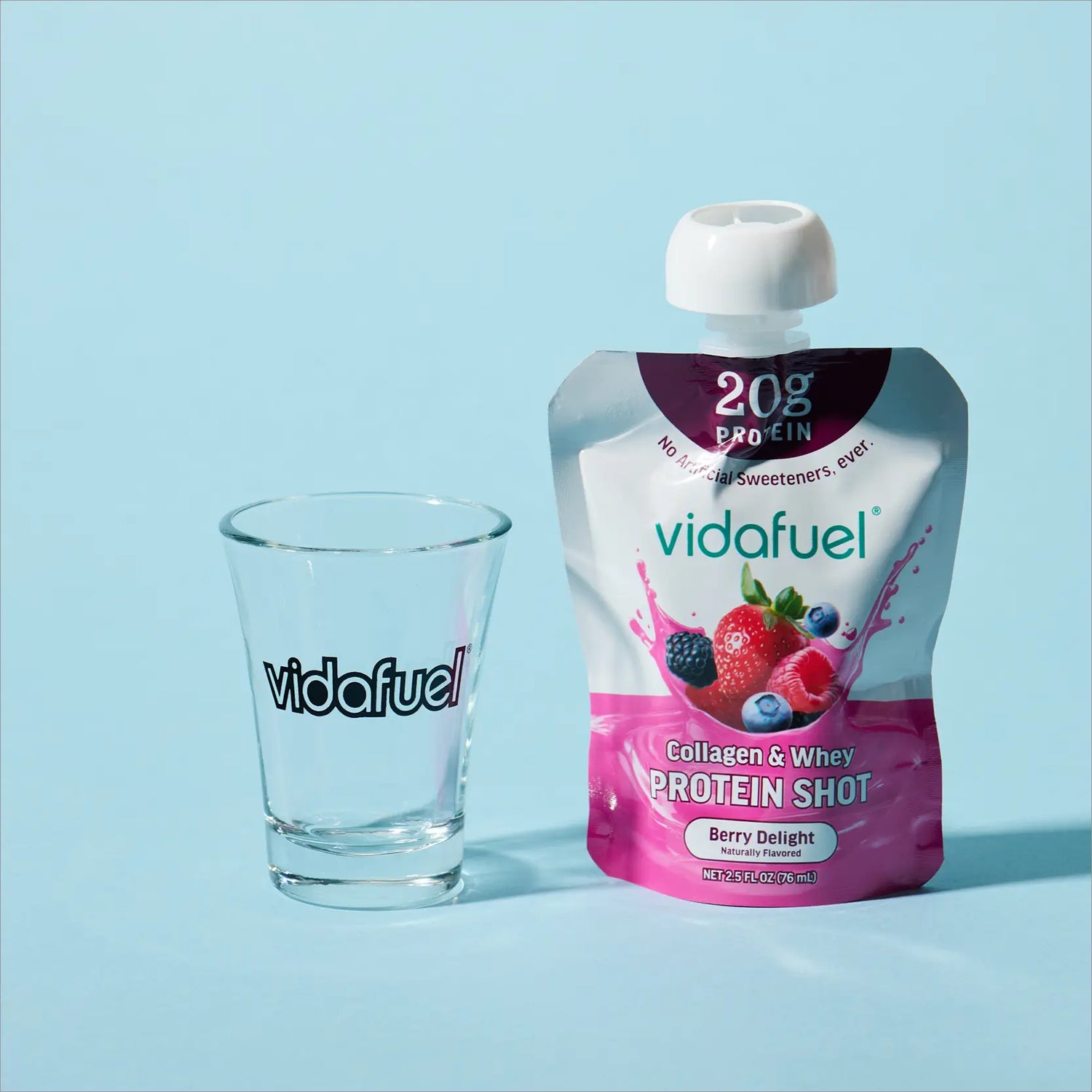 Vidafuel protein shot pouch and glass on a light blue background